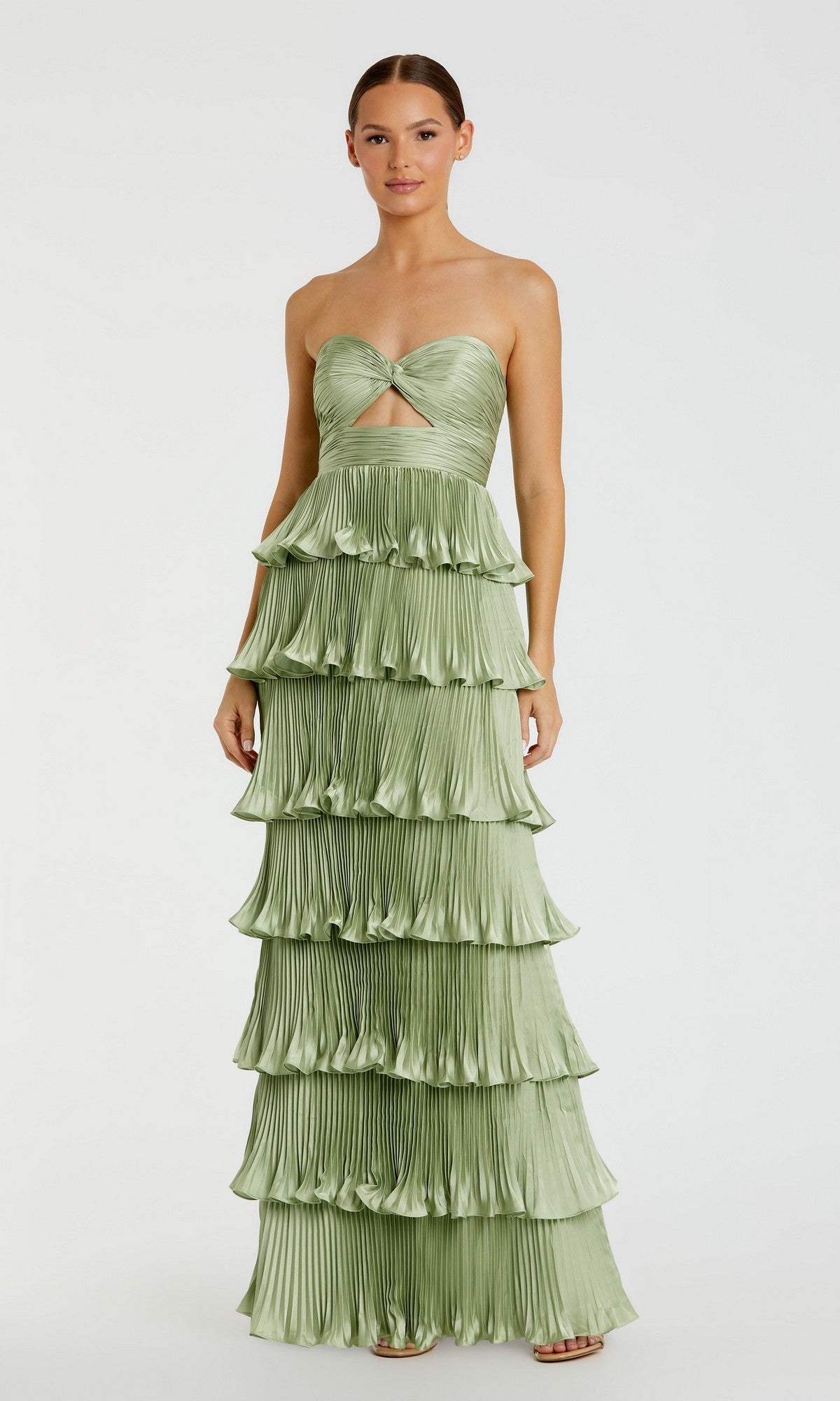 A woman stands against a plain white background wearing the Long Formal Dress: Mac Duggal 49981 in sage, a strapless, tiered pleated gown featuring a midriff cutout.